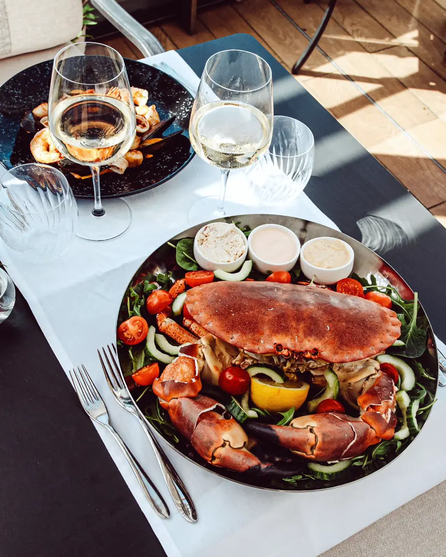 A whole chancre crab with salad, oysters and white wine on the terrace