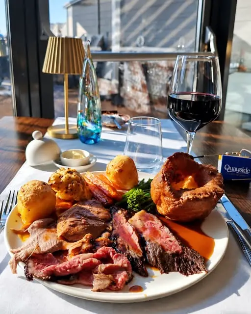 Sunday roast beef with Yorkshire pudding and a glass of red on the terrace